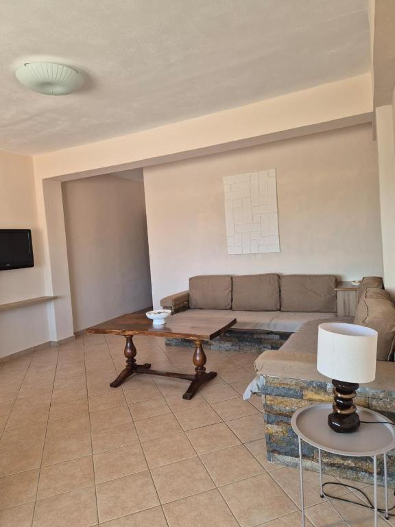 a living room with a couch and a table at Kohil Guest House in Ksamil