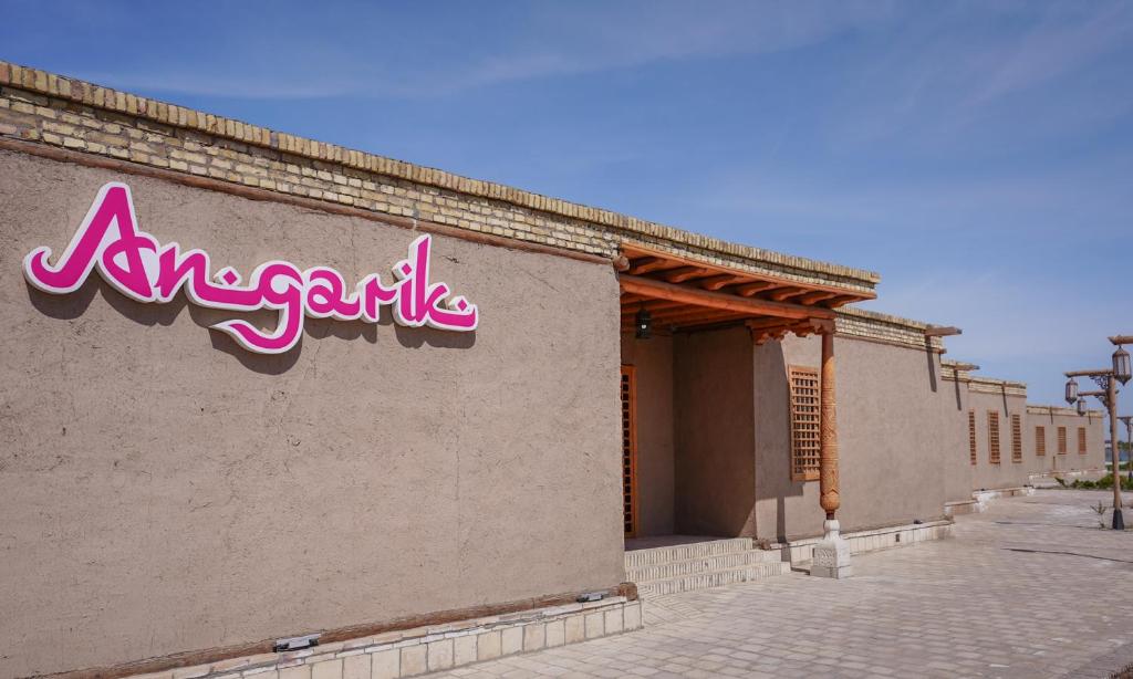a sign on the side of a building at Arda Angariki in Khiva