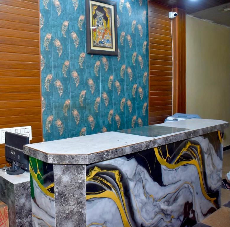 a table in a room with a blue wall at Queen Palace in Mathura