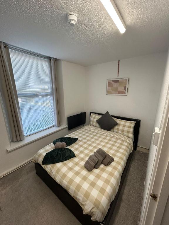 a bedroom with a bed with two pillows on it at Boho Bliss in Swansea