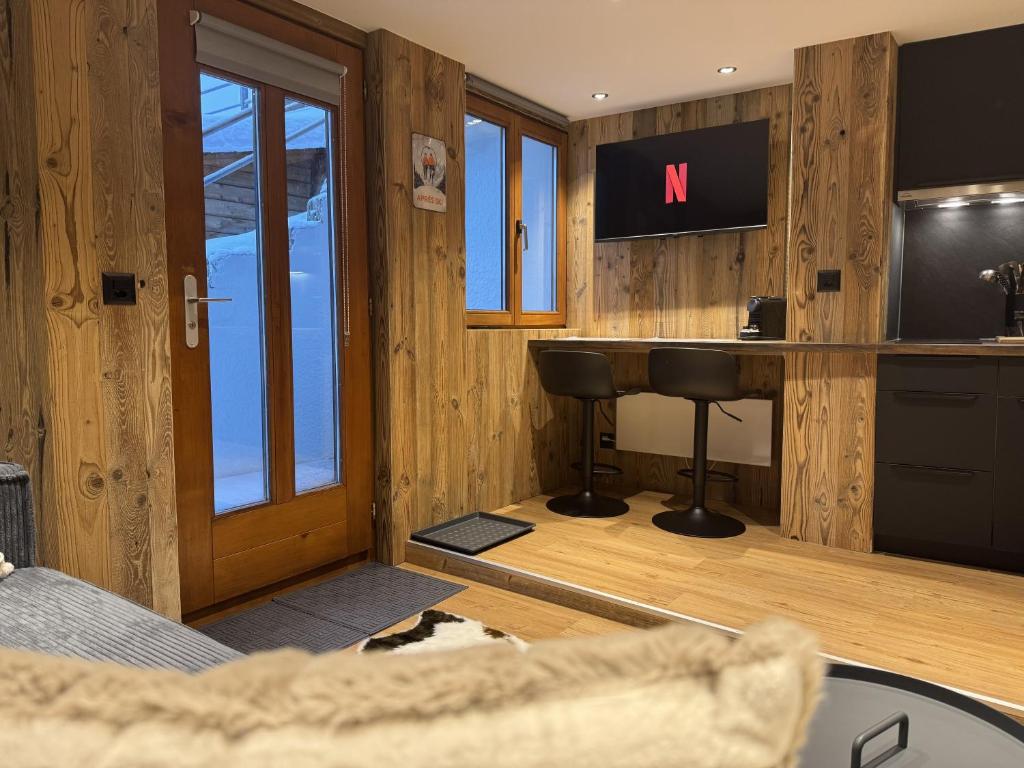 a room with a bar with a sink and a desk at Studio alpin au centre de la station in Saas-Fee