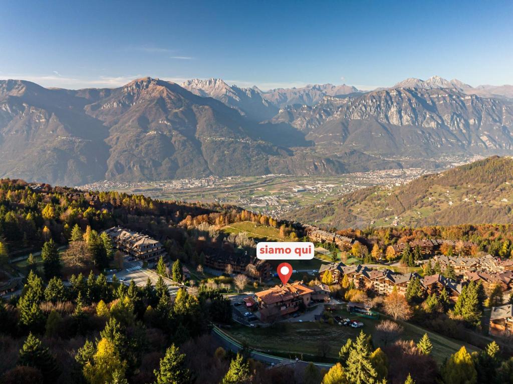 an aerial view of a resort with mountains in the background at Albergo Legazzuolo Montecampione in Artogne