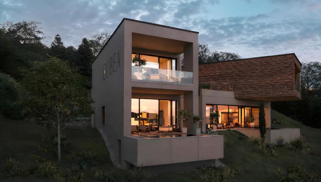 a house with a large window on a hill at Cubea in Bodenmais
