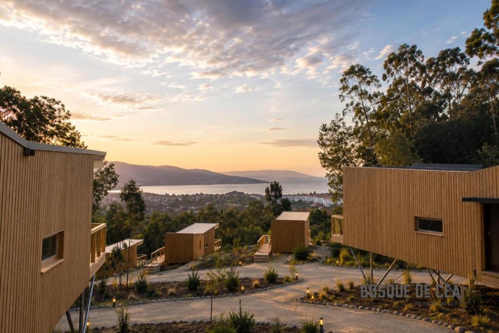 a group of buildings with a view of a lake at Bosque de Cea in Nigrán