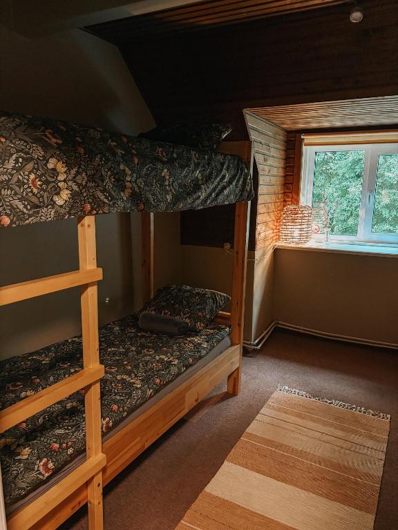 two bunk beds in a room with a window at Pargi apartment 2 in Viljandi