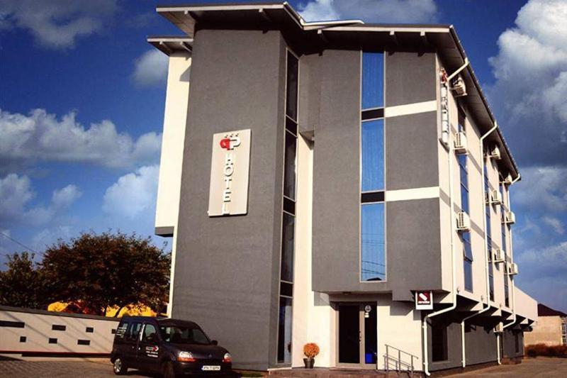 a building with a car parked in front of it at GP Hotel StarCity in Tătărani