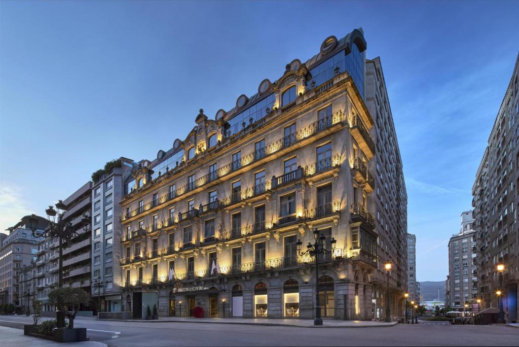 a large building in a city at night at NH Collection Vigo in Vigo