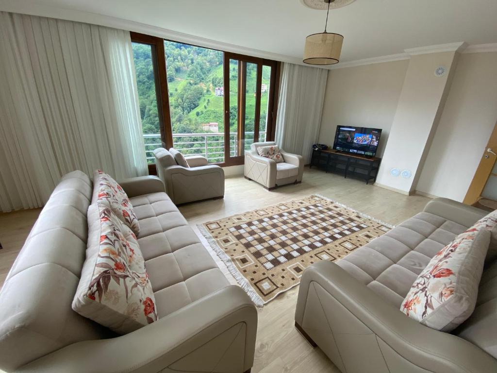 a living room with two couches and a chessboard at Komilo Homes - Functional Modern Suite in Çamlıhemşin