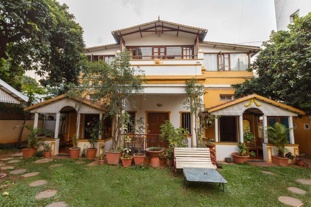 a house with a bench in front of it at Casa Cottage in Bangalore