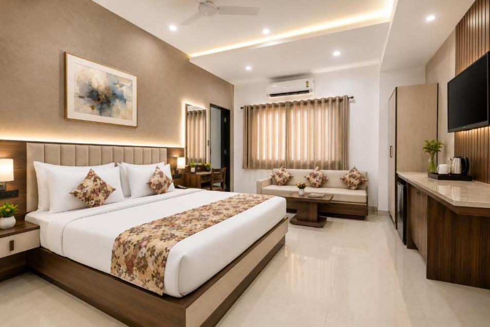 a hotel room with a bed and a television at Ashish Palace - A City Centre Hotel in Udaipur