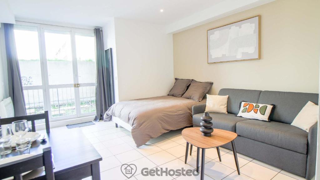 a living room with a couch and a table at La Villette - Charming flat in Pantin - GetHosted in Pantin