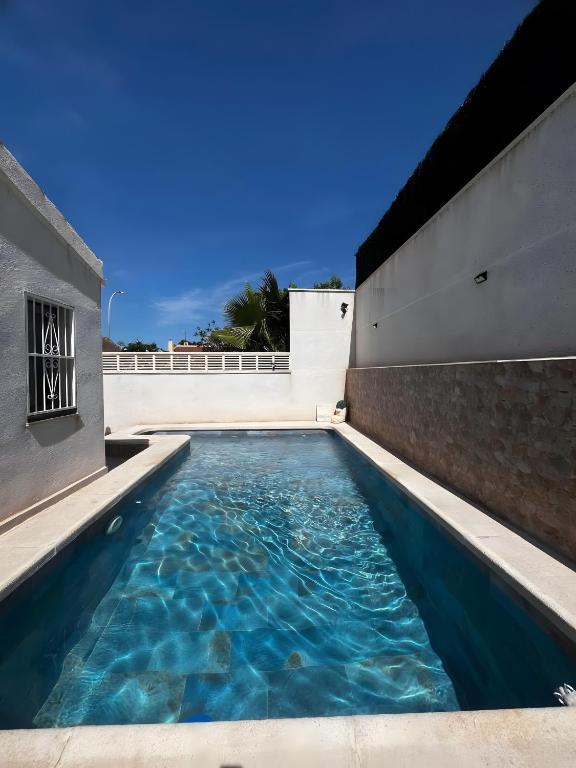 a swimming pool on the side of a building at Sam in San Fulgencio