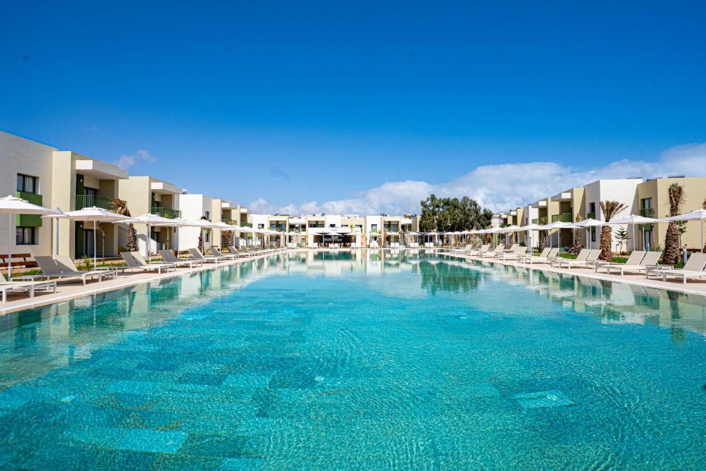 a large pool of blue water in a resort at Zephyr Saidia in Saïdia