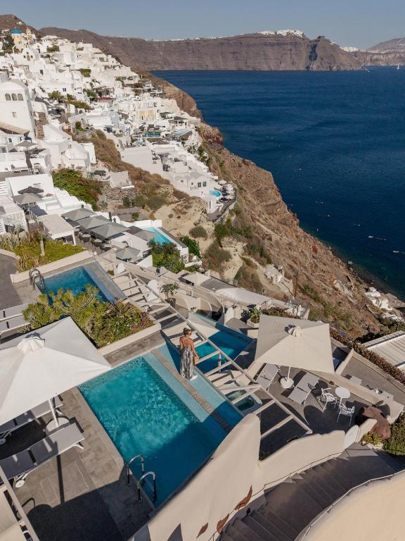 an aerial view of a resort with a swimming pool at Mancave Sanctum Caldera Suites in Oia