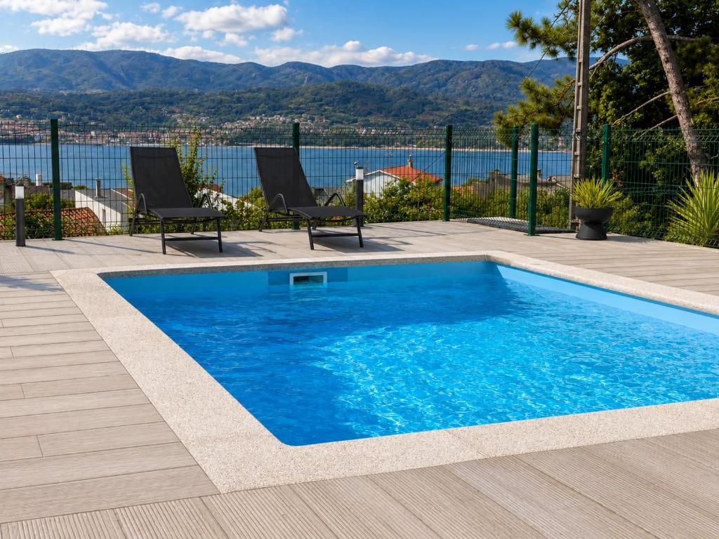 a swimming pool with a view of the water at Carimar, a mirada da ría in Boiro