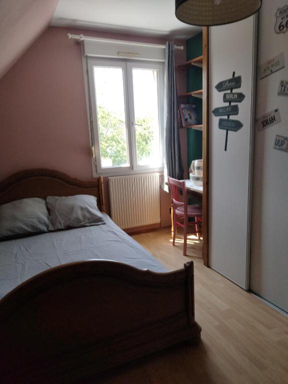 a bedroom with a bed and a window and a desk at La chapelle 4 chambres - 4 lits doubles in Teloché