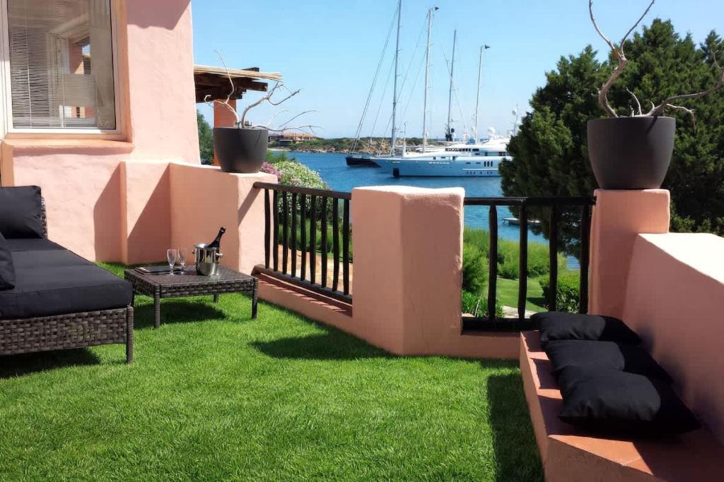 a balcony of a house with a view of the water at LUX-Porto Cervo Center Sea View Apartment in Porto Cervo