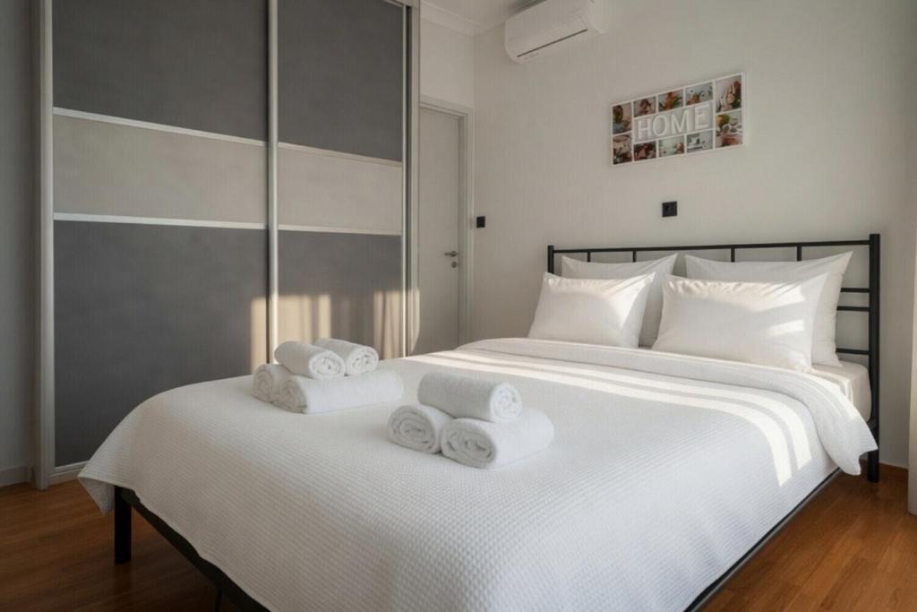 a bedroom with two beds with towels on them at Voula Asklipeio Residence Supreme in Athens