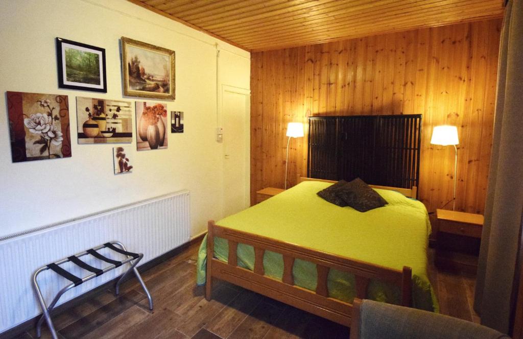 a bedroom with a bed and a chair in it at Christys Palace Hotel in Pedoulas