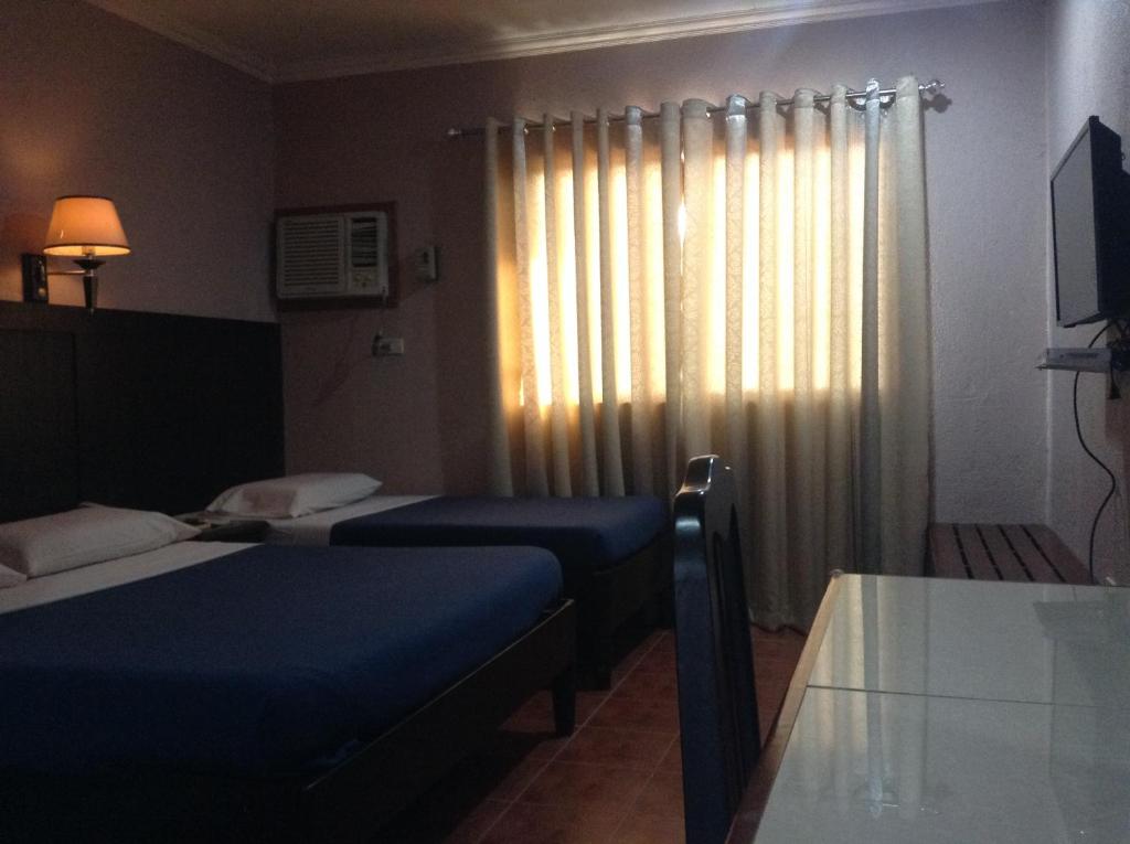 Postel nebo postele na pokoji v ubytování Miami Inn