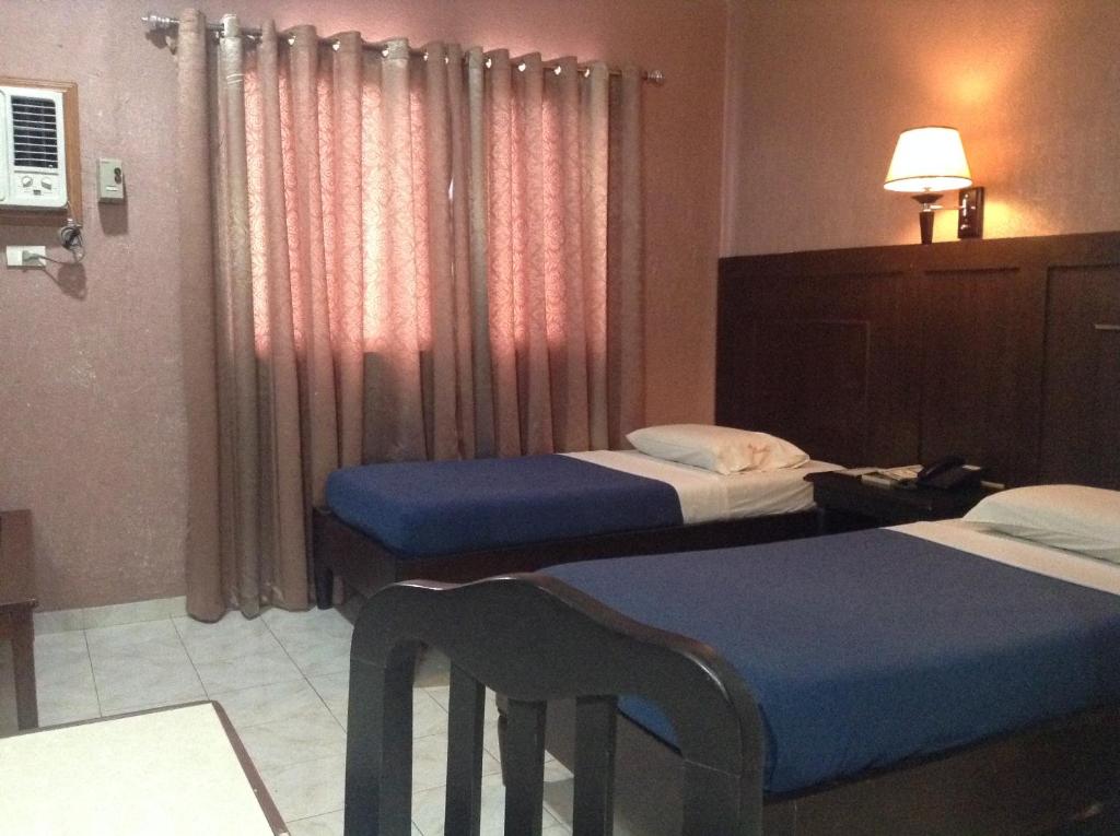 Postel nebo postele na pokoji v ubytování Miami Inn