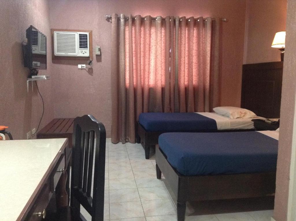 Postel nebo postele na pokoji v ubytování Miami Inn
