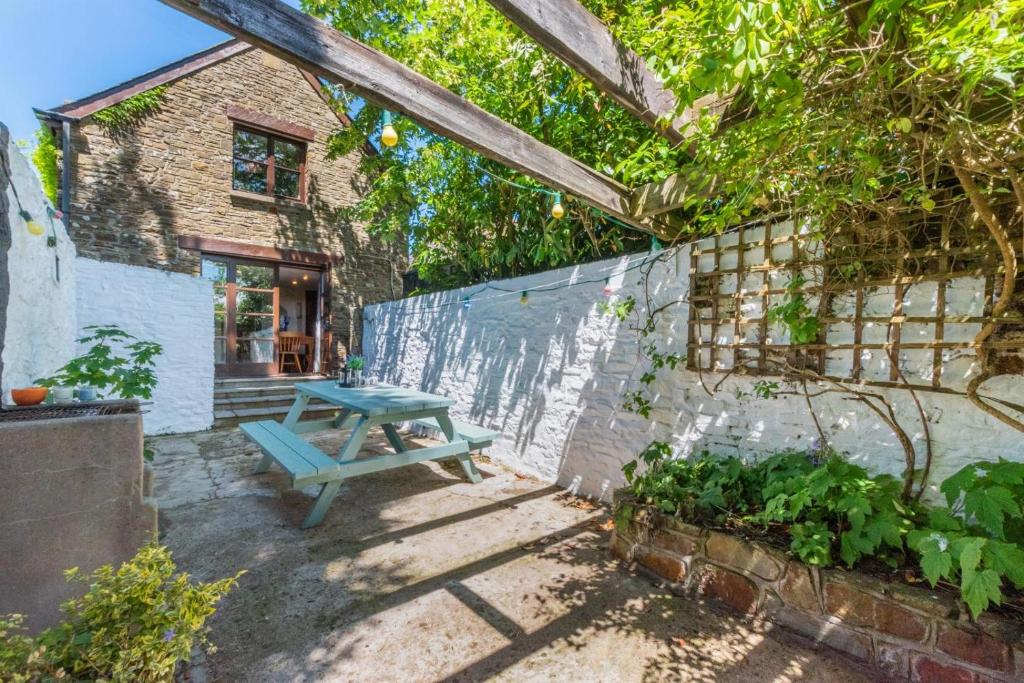 a blue picnic table in the courtyard of a house at 4 Bed in Westward Ho oc-n1623 in Westward Ho