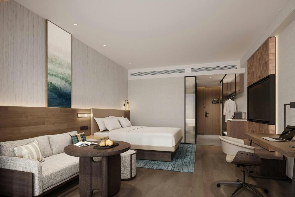 a hotel room with a bed and a desk at Fairfield by Marriott Kunming Xishan in Kunming