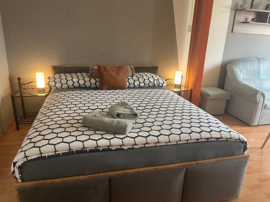 a bedroom with a large bed with two lamps at Apartman QUATTRO in Sokolov