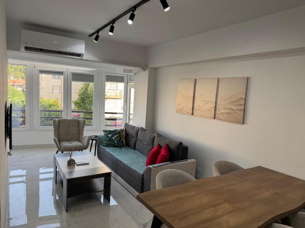a living room with a couch and a table at Stylish Ohrid Apartment, Hot Tub, Steps to Lake in Ohrid
