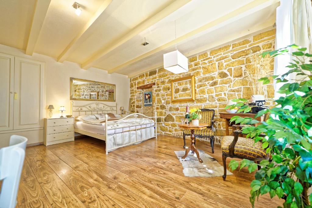 a room with a bed and a stone wall at Duplex Apartment Camelia in charming Old town in Rovinj