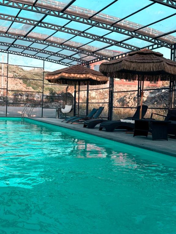 a large swimming pool with chairs and umbrellas at Cascade Resort Sevan in Sevan