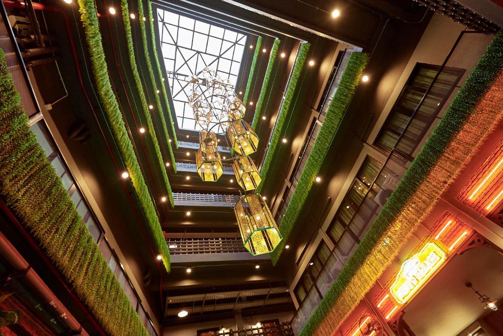 an overhead view of a building with a chandelier at W22 by Burasari in Bangkok