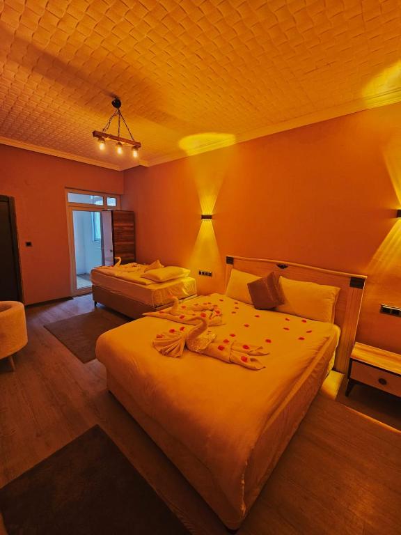 a hotel room with two beds in a room at novela in stone house in Uçhisar