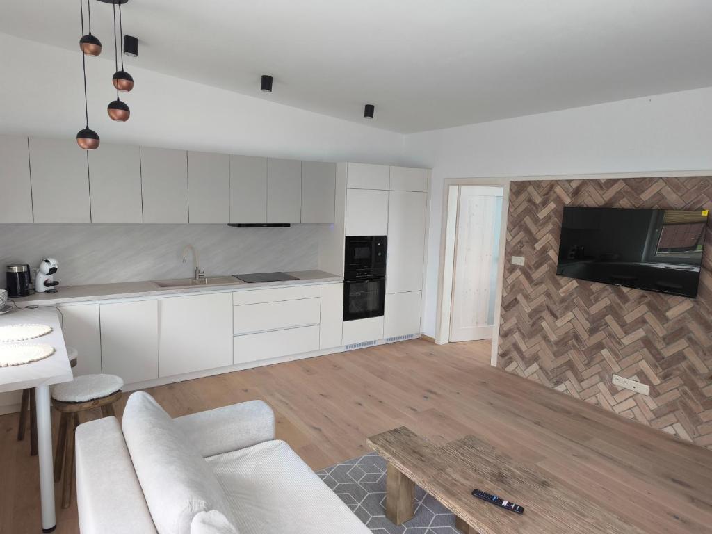 a kitchen with a couch and a table in a room at Dubrowes cottage in Bobrów