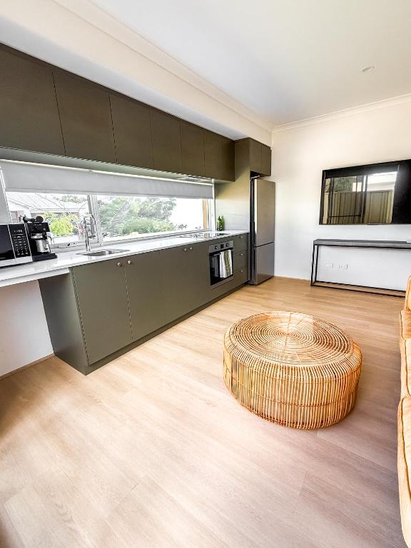 a kitchen with a circular ottoman in the middle of a room at The Sierra in Dunsborough