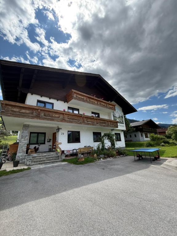 a building with a picnic table in front of it at Pension Mitterwallner in Schladming
