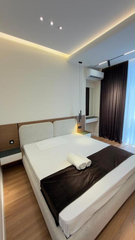 a large white bed in a room with a window at Apt Elite in Khujand