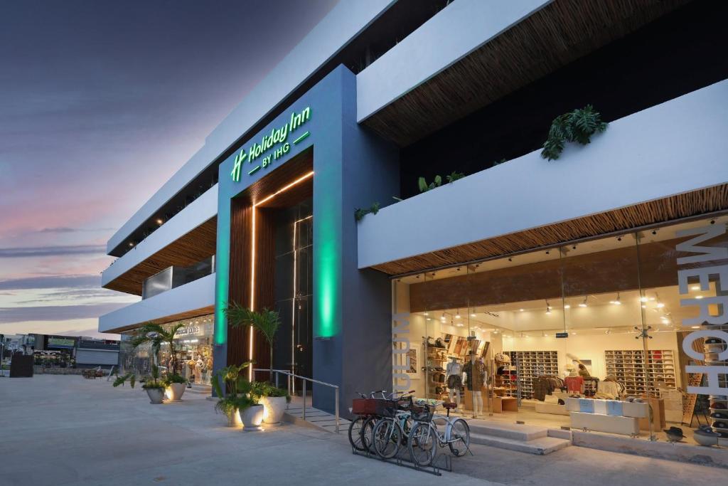 a store front with bikes parked outside of it at Holiday Inn Tulum by IHG in Tulum