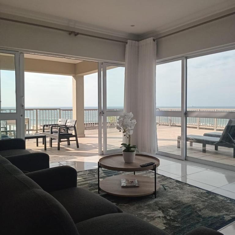 a living room with a couch and a table at Cabana Vista 4 in La Mercy