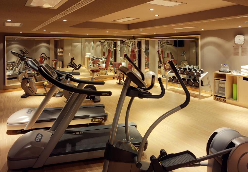 a gym with several cardio machines in a room at HYPERION Hotel Dresden Am Schloss in Dresden
