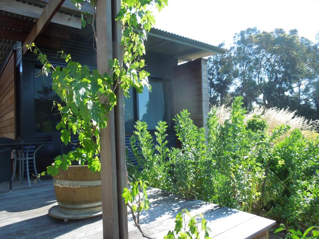 a porch of a house with plants on it at Beach Side Garden Apartment in Perth