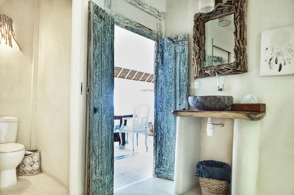 a bathroom with a mirror and a sink and a toilet at Sal Secret Spot in Uluwatu