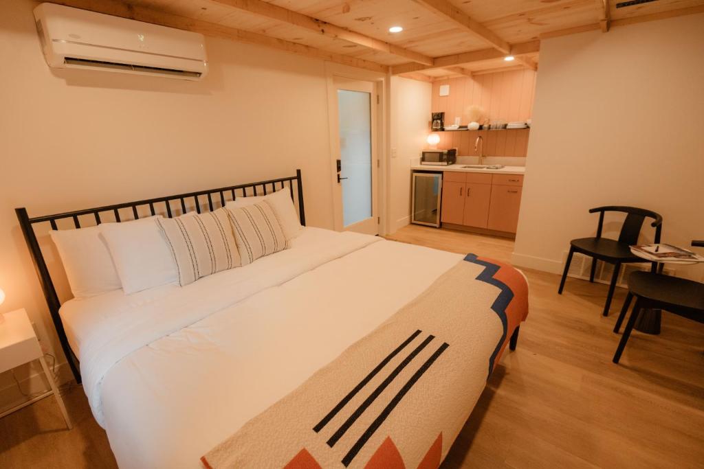 a bedroom with a large bed and a kitchen at The Mill House in Bayfield