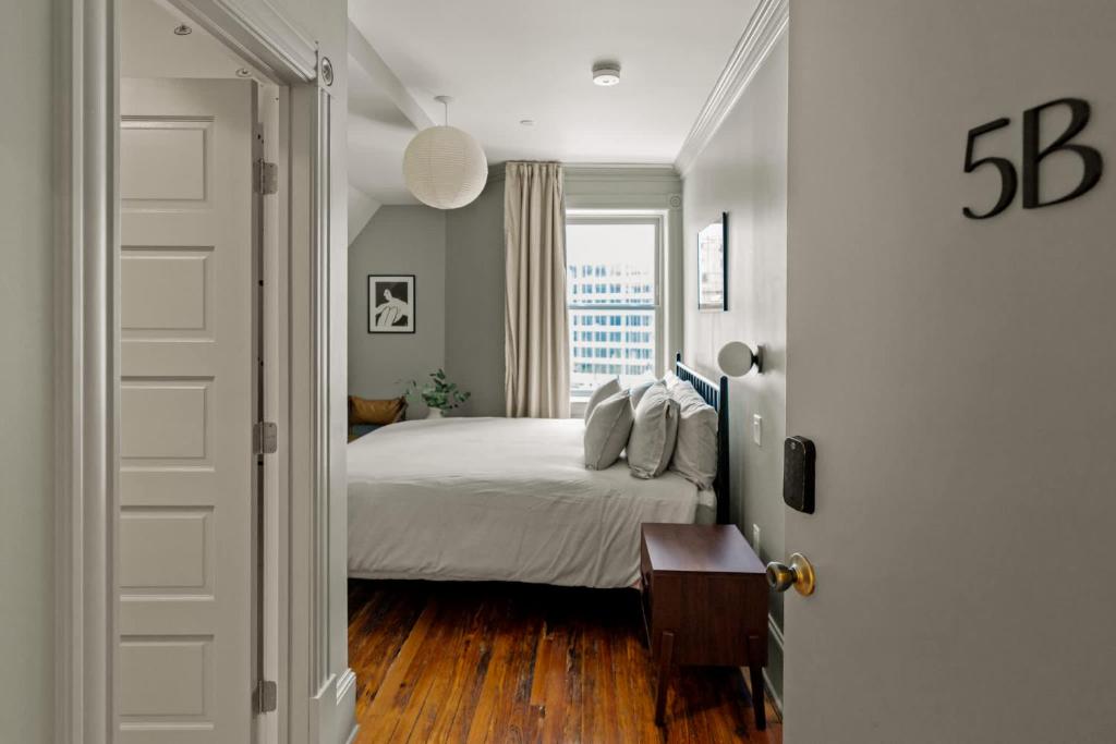 a bedroom with a bed and a window at Suite 5B at Maison Dupont a Dupont Circle Inn in Washington, D.C.