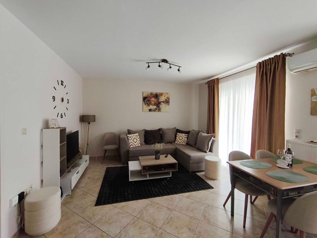 a living room with a couch and a table at PERLA apartment in Alexandroupoli