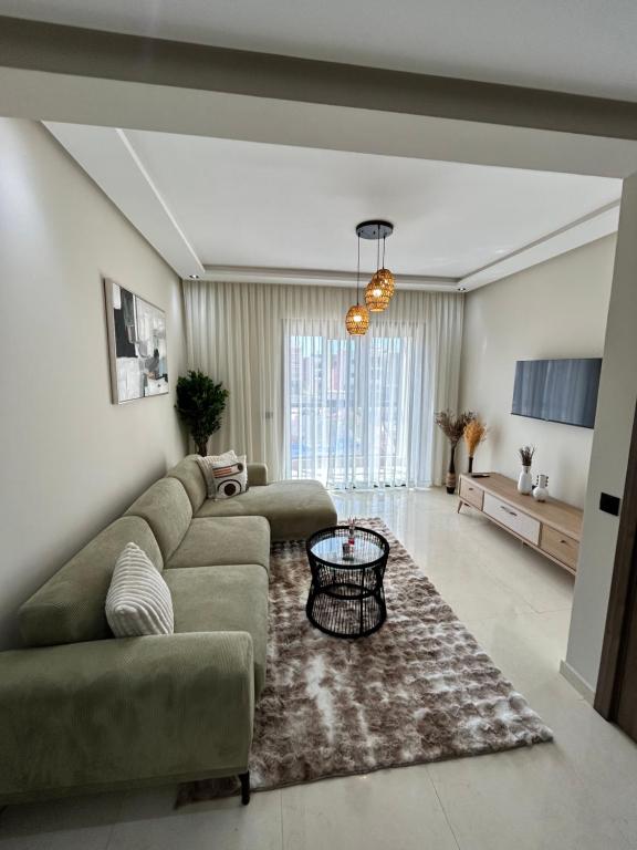 a living room with a couch and a table at Nakhla in Dar Bouazza