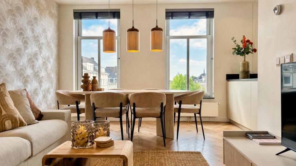 a living room with a table and chairs at Cooth's Prestige at the Square in Breda