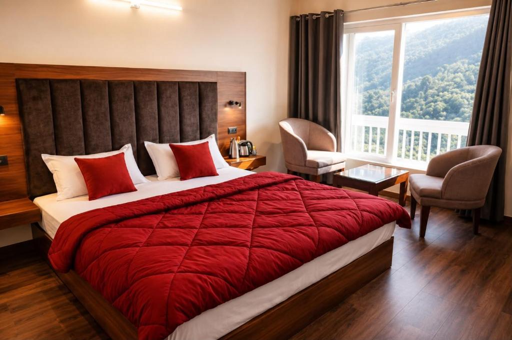 a bedroom with a large bed with a red blanket at The Oak Lake Cottage Boho in Nainital