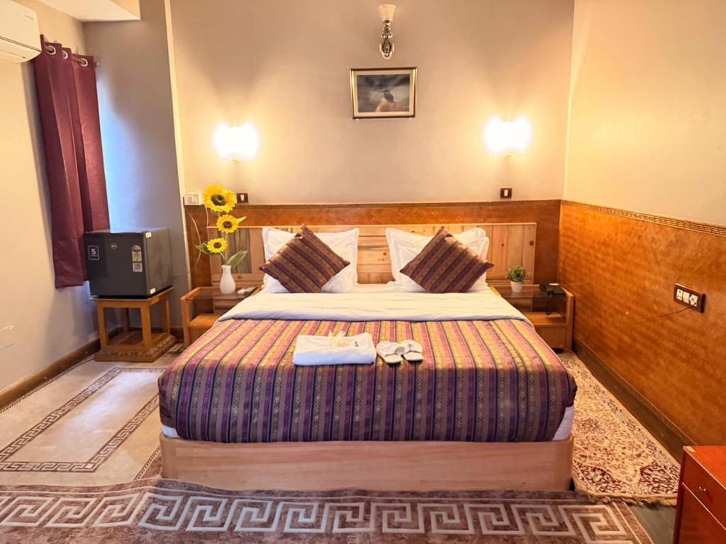 a hotel room with a bed and a television at Hotel Pelri in Phuntsholing